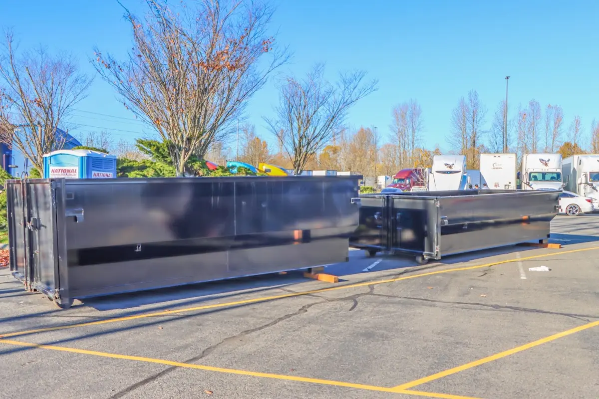 Professional dumpster rental service with roll-off container on residential driveway in Westborough